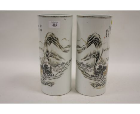 A PAIR OF ORIENTAL CERAMIC HAT STANDS / CYLINDRICAL VASES WITH HAND PAINTED MOUNTAINOUS LANDSCAPE DETAIL. CHARACTER MARKINGS 