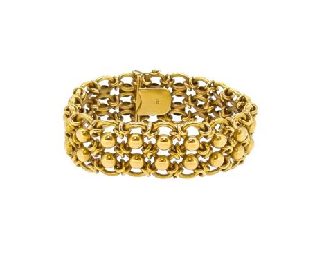 A decorative wide bracelet, articulated oval and domed disc links, length 20cm, width 2.3cm, push-in clasp with figure of eig
