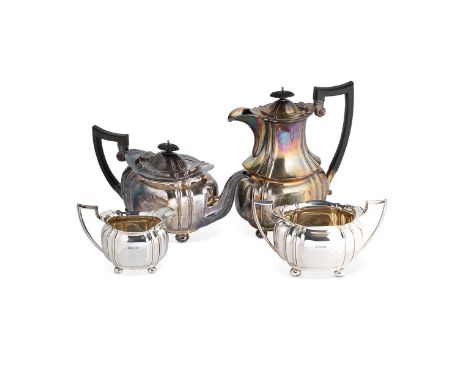 An Edward VII silver 4-piece tea set, mark of Cooper Brothers &amp; Sons Ltd., Sheffield 1909, the teapot of oval panelled fo