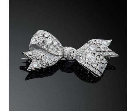 An early 20th century diamond set bow brooch, set with transitional brilliant and eight cut diamonds (one lacking), estimated