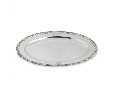 A George III silver platter, mark of Timothy Renou, London 1802, of oval form with gadrooned rim, crested, 39 x 28cm, 1280g (