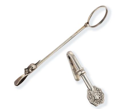 A rare continental metalwares skirt lifter, together with a silver napkin clip, the skirt lifter stamped 835, no further appa