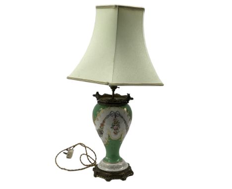 Large 19th century porcelain table lamp, the body hand painted with floral swags and ribbons, with beaded and ornately cast b