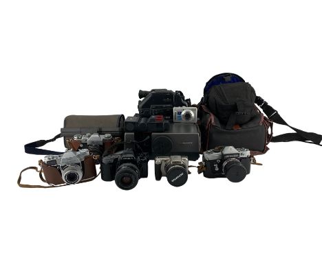 Various vintage and later cameras including Kodak Retina Reflex SLR, Zenit, Petri Flex, JVC Videomovie, Hanimex slide project