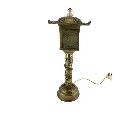 20th century Chinese brass Pagoda form table lamp, the stem cast in relief with a coiled dragon and the shade cast with two P