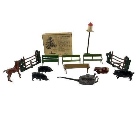 Meccano miniature oil can marked 'K' to the side and Meccano to base, a pair of Britains lead garden benches, Britains farm i