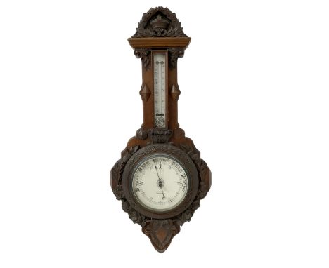 J Hall of Bradford - Early 20th century carved oak-cased aneroid barometer with applied carving to the pediment and dial surr