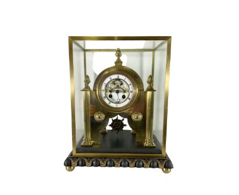 French -   8-day Parisian clock movement re-housed in a 20th century bespoke constructed brass frame within a glass case, wit