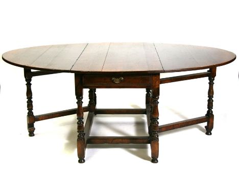 A large 18th century style oak gate-leg dining table by Dodge of Sherborne. 137cm (54 ins) wide