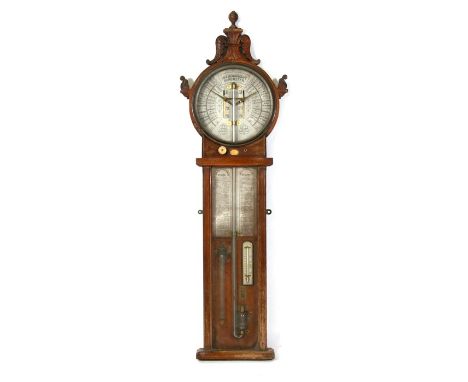 An L Dixey Atmoscope barometer fitted in an oak case, 117cms (46ins) high.