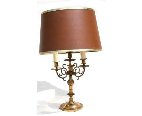A brass three-arm table lamp.
