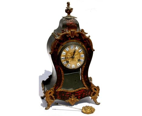 A 19th century French boulle work mantle clock, the gilt metal dial with enamel Roman numerals, the movement striking on a be