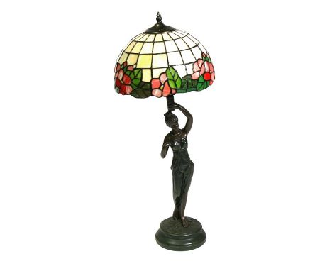 A figural bronzed table lamp with Tiffany style shade, 75cms (29.5ins) high.