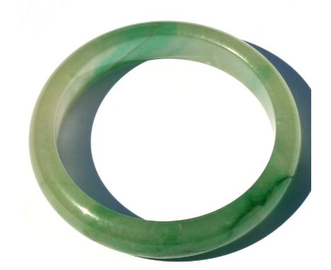A Chinese jadeite bangle, weight 47g, 7.5cms (3ins) diameter.