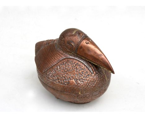 A Cambodian copper betal nut / leaf box in the form of a bird, decorated with foliate scrolls with silvered interior, 28cms (