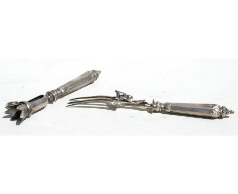 A 19th century French white metal handled carving fork, the safety guard in the form of a stag; together with a matching ham 