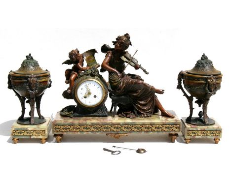 A French bronzed spelter &amp; figured green marble clock garniture, the white enamel dial with Arabic numerals, surmounted w