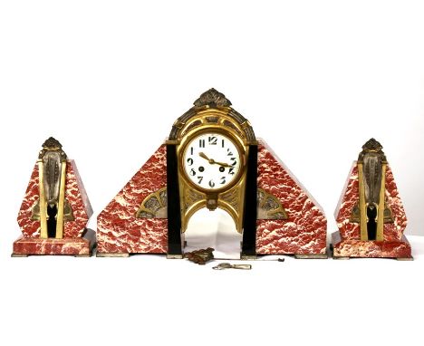 A French Art Deco rouge marble &amp; gilt metal mounted clock garniture, the cream enamel dial with Arabic numerals, the move