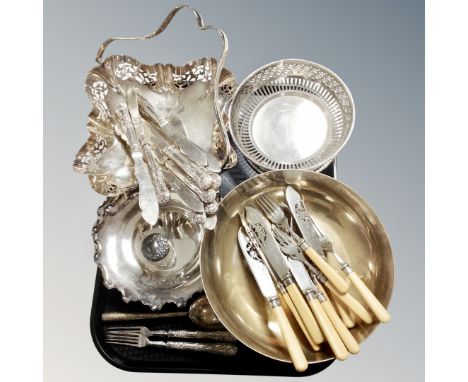 A tray containing assorted plated baskets and bowls, plated flatware, fish cutlery, silver lidded jar, together with two silv