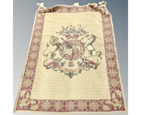 A wall tapestry depicting a coat of arms. 