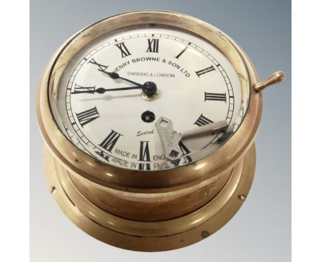 A brass ships clock with key by Henry Browne and Son. 