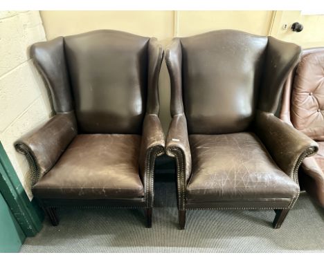 A pair of brown button leather 20th century armchairs 