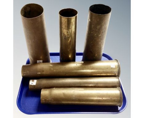 Six brass ammunition shells. 