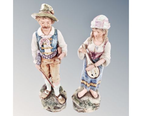 A pair of 19th century continental figures of travelling musicians. 