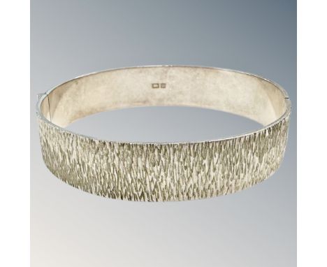 A textured silver bangle, diameter 6cm.  CONDITION REPORT: 27.3g