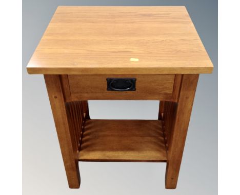 A contemporary oak lamp table fitted a drawer 