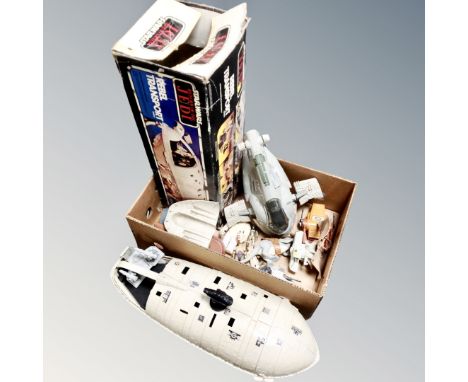 A box containing vintage Star Wars vehicles to include rebel transport vehicle with original box, small quantity of figures. 