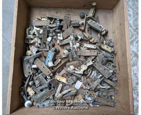 A box of sash window latches. Mostly Victorian brass 