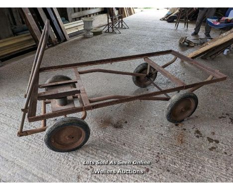 Vintage trolley on wheels with solid rubber tyres. All wheels turning, front axle. Angle iron frame is solid. 92cm W x 184cm 