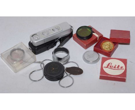 A small group of camera lenses, filters and similar, including Leica, Leitz, a 'Wratten' filter No 1A, a KODISK attchment 320