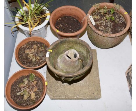 A selection of garden planters, including: a pair of terracotta footed bow form planters; two larger terracotta garden plante