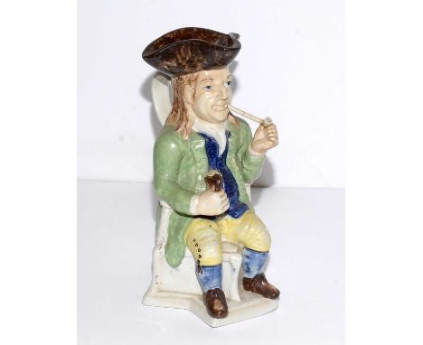 A Staffordshire 'The Squire' toby jug, modelled as a seated gentleman smoking a pipe, 28cms high.