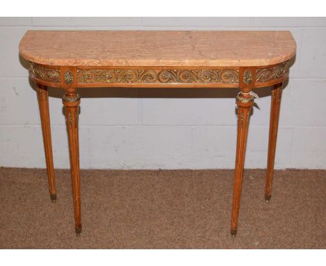 A reproduction Italian style marble-topped console table, with gilt brass applied frieze, reeded tapering supports and peg fe