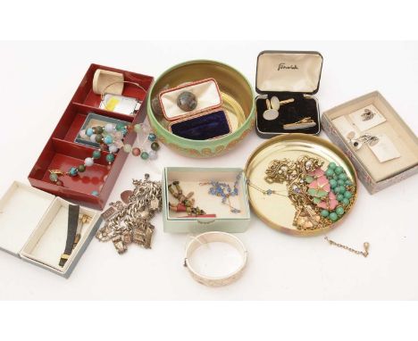 A quantity of costume jewellery, including: a moss agate and silver brooch; a paste set drop pendant; a silver charm bracelet