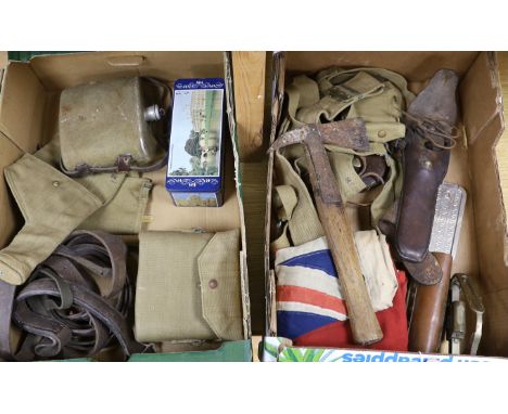 A collection of militaria including a union flag, gunners sight, camouflage webbing, a water bottle, an axe, a bosun’s whistl