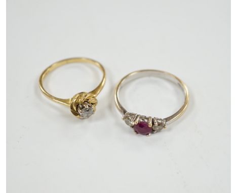 A modern 18ct white gold, ruby and diamond set three stone ring, size N/O and a 1970's 18ct gold and solitaire diamond set ri