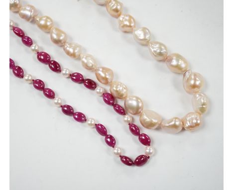 A modern cultured pearl and polished ruby? bead necklace, with two stone diamond chip set 750 clasp, 166cm and a modern baroq