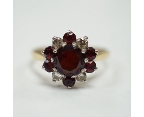 An 18ct red paste? and diamond cluster set flower head ring, size M, gross weight 3.2 grams.