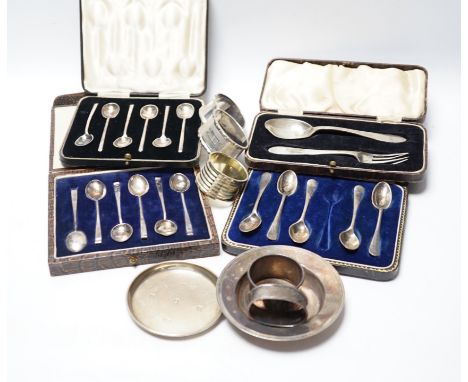 Four various silver serviette rings and a plated napkin ring, two small silver dishes, three various boxed sets of silver fla