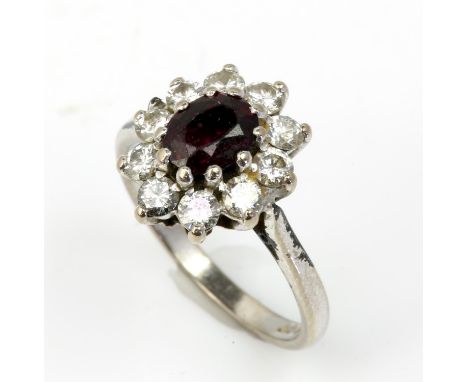 Ruby and diamond cluster ring, oval cut ruby weighing an estimated 1.15 carat, surrounded by ten round brilliant cut diamonds