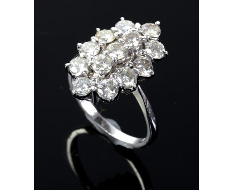 Diamond cluster ring, an oblong design with three round brilliant cut diamonds to the centre, with a further surround of ten 