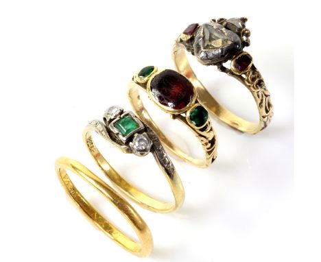 Selection of gold rings, including a band ring in 22 ct yellow gold, an emerald and diamond three stone ring in stamped 18 ct