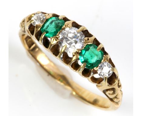 Emerald and diamond five stone ring, three graduated old cut diamonds with two cushion cut emeralds set in between, mounted i