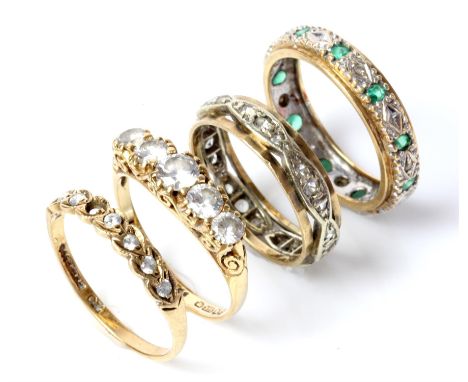 Emerald and diamond band ring, mounted in stamped 9 ct white and yellow gold, size O, a white paste set band ring, in  9 ct w