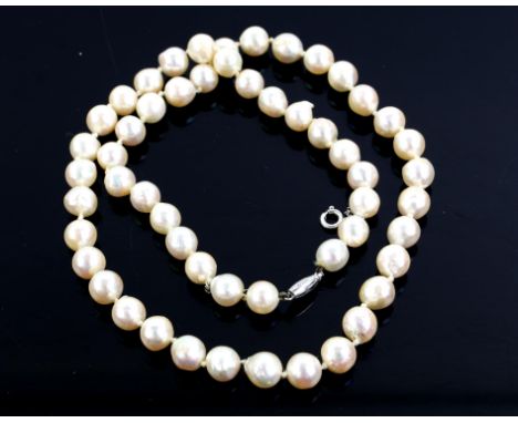 Single row pearl necklace, fifty-four round cultured pearls measuring approximately 7-7.5mm, on an white metal clasp, stamped