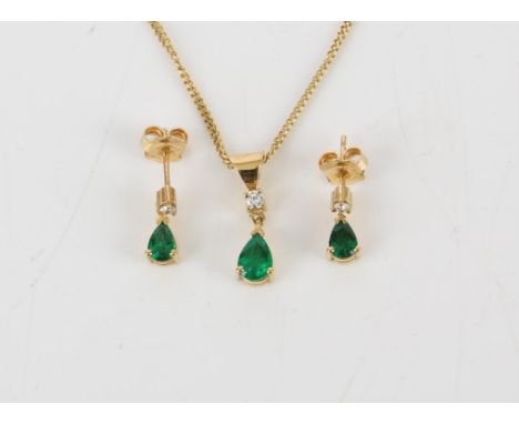 Emerald and diamond pendant and matching earrings, a pear shaped emerald with a round brilliant cut diamond set above, on a f